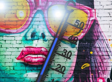 Illustration: Person mit Sonnenbrille auf einer Backsteinwand und Thermometer