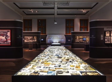 Blick in die Ausstellung »Flashes of Memory«, in der Mitte der Leuchttisch mit thematisch nicht sortierten Aufnahmen